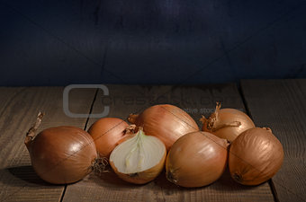 Onions lies on the old wooden table