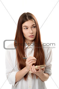 young woman holding a notepad and pen