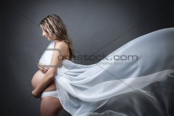 Portrait of a pregnant woman wrapped in cloth