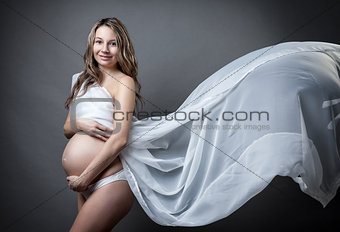 Portrait of a pregnant woman wrapped in cloth