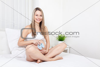 Pregnant woman relaxing on the bed