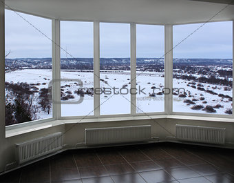 wide window of verandah with winter landscape