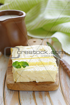 block of fresh organic butter on a wooden board