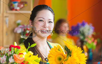 Smiling Woman in Flower Shop with Sunflowers