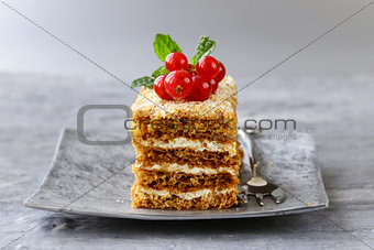 portioned dessert piece of cake with cream and berries
