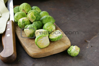 raw fresh organic brussels sprouts on cutting board