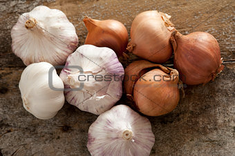 Fresh raw whole garlic bulbs and onions