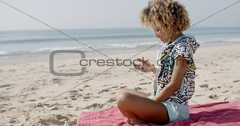Woman Listening To Music On The Beach