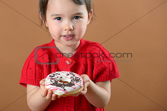 little girl holding donuts