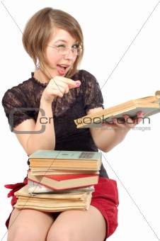 attractive girl sitting with heap of the books and give a wink