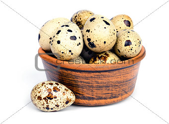 Quail eggs in a ceramic bowl.