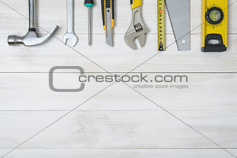 Top view of construction instruments and tools on wooden DIY workbench. with open space.