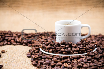 White coffeecup on coffeebeans