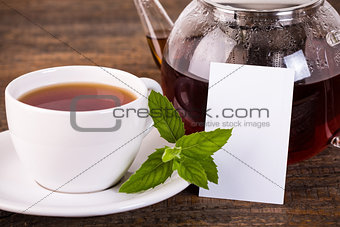 Teapot and white cup with white label