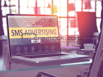 SMS Advertising on Laptop in Modern Workplace Background.