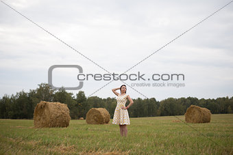 beautiful girl smiling in a dress the field