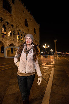 Happy young woman walking near Dogi Palace St. in Venice