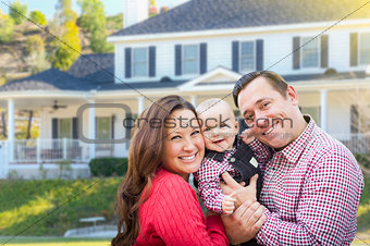 Young Family With Baby Outdoors In Front of Custom Home