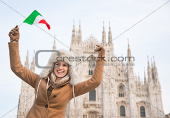 Happy woman tourist with Italian flag rejoicing near Duomo
