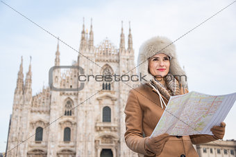 Woman tourist with map looking aside in the front of Duomo