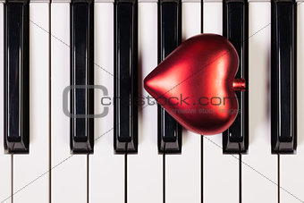 Piano keyboard and red heart