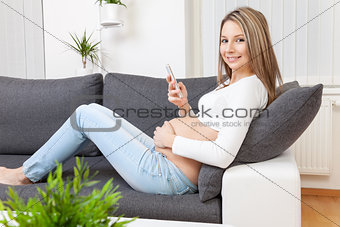 Beautiful pregnant woman relaxing at home