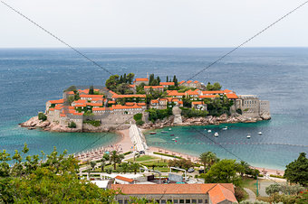 Sveti Stefan island view from hills in windy summer day
