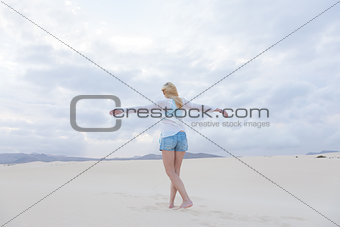 Carefree woman enjoying freedom on beach.