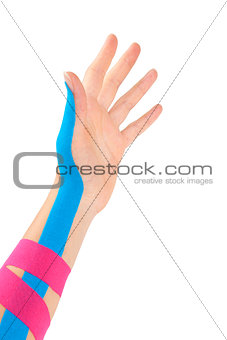 Kinesio tape on female hand.