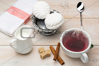 Set of cup red tea and dessert