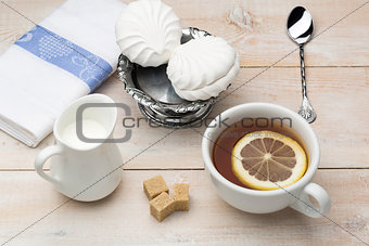 Cup of black tea with slice lemon