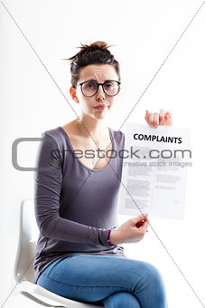 sitting woman showing a form with complaints