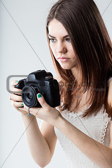 beautiful girl holding a reflex camera