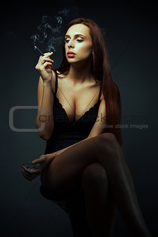 attractive sexy girl with cigarette dark scene