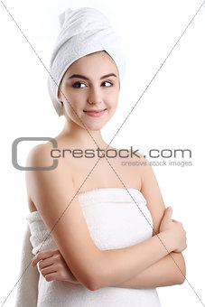 Spa Woman. Portrait of smiling young woman in towel in bathroom.