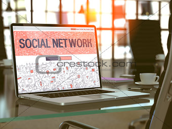 Social Network on Laptop in Modern Workplace Background.