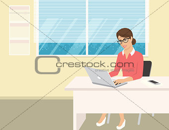 Business woman wearing rose shirt sitting in the office and working with laptop