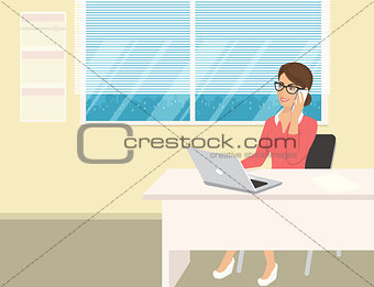 Business woman wearing rose shirt sitting in the office and talking by cellphone