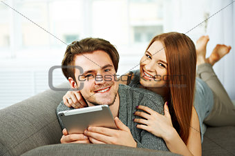 Young couple browsing the Internet on a tablet