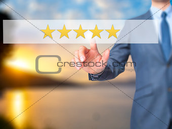 Five star rating - Businessman hand pressing button on touch scr