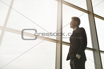Stylish business man in the background of a large window