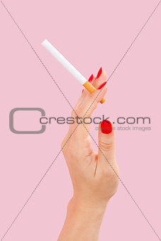 Female hand holding cigarette.