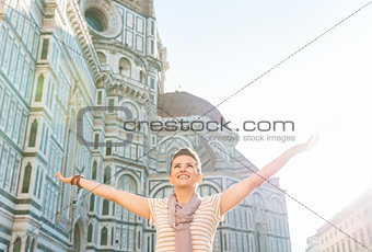 Happy woman tourist rejoicing in the front of Duomo, Florence