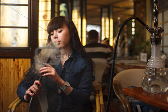Beautiful young woman with hookah
