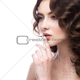 Portrait of beautiful girl with a gentle makeup, curls and crystals on the body. beauty face.