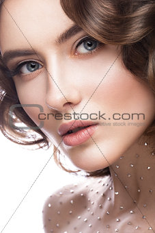 Portrait of beautiful girl with a gentle makeup, curls and crystals on the body. beauty face.