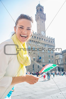 Portrait of smiling woman with Italian flag near Palazzo Vecchio