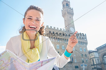 Woman with map near Palazzo Vecchio pointing on something