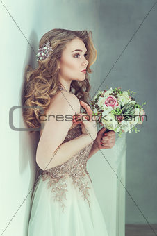 Beautiful bride in wedding dress. Portrait of young bride. Studio shot.