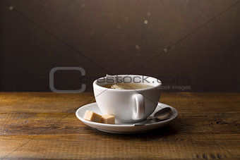 Tea cup with tea bag on saucer